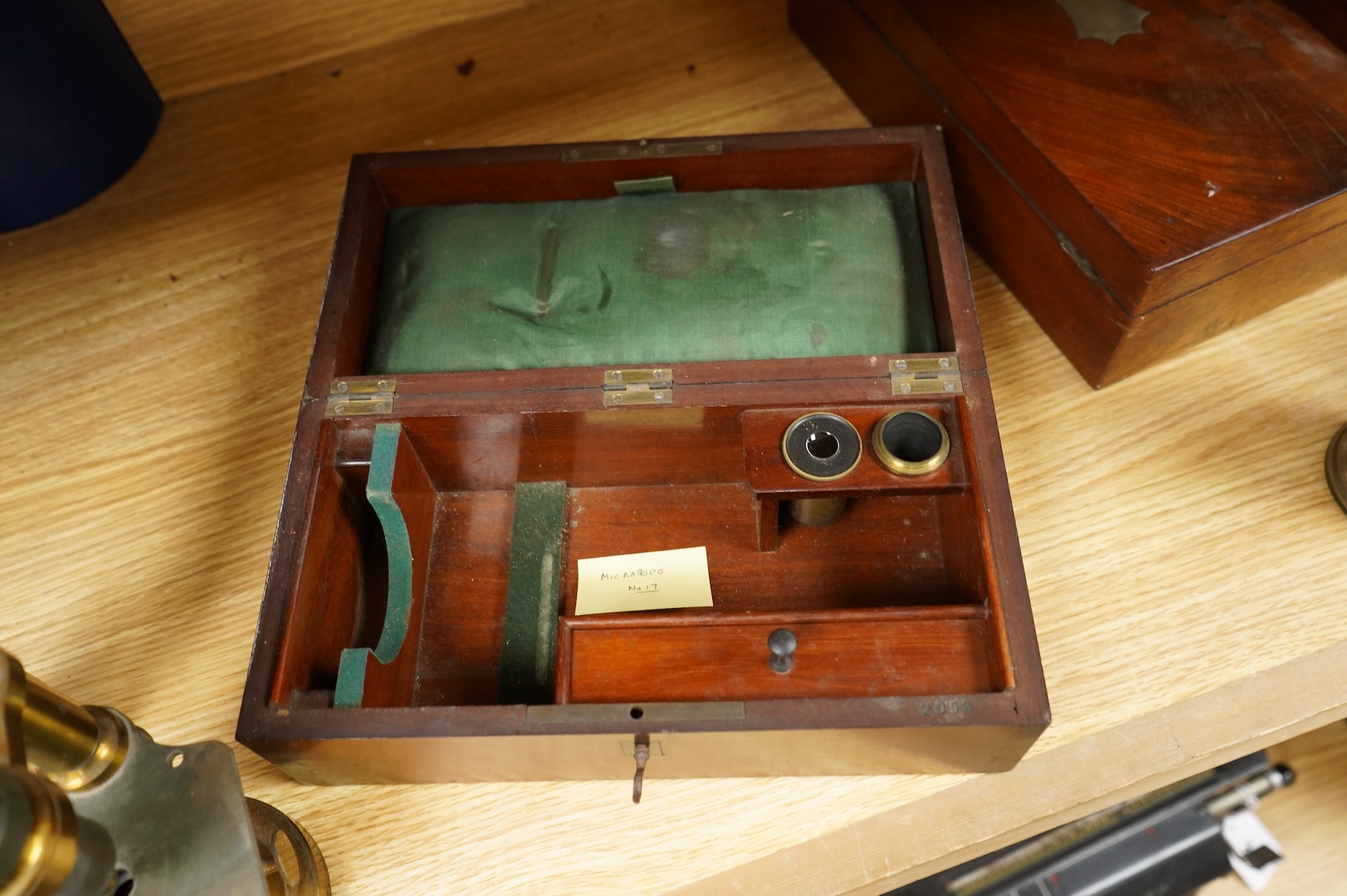 A mid 19th century French brass compound monocular microscope, by G. Oberhaeuser & E. Hartnack, Place Dauphine, Paris, number 2953, with an additional eyepiece, an objective and small box of slides, mahogany case 25.5cm